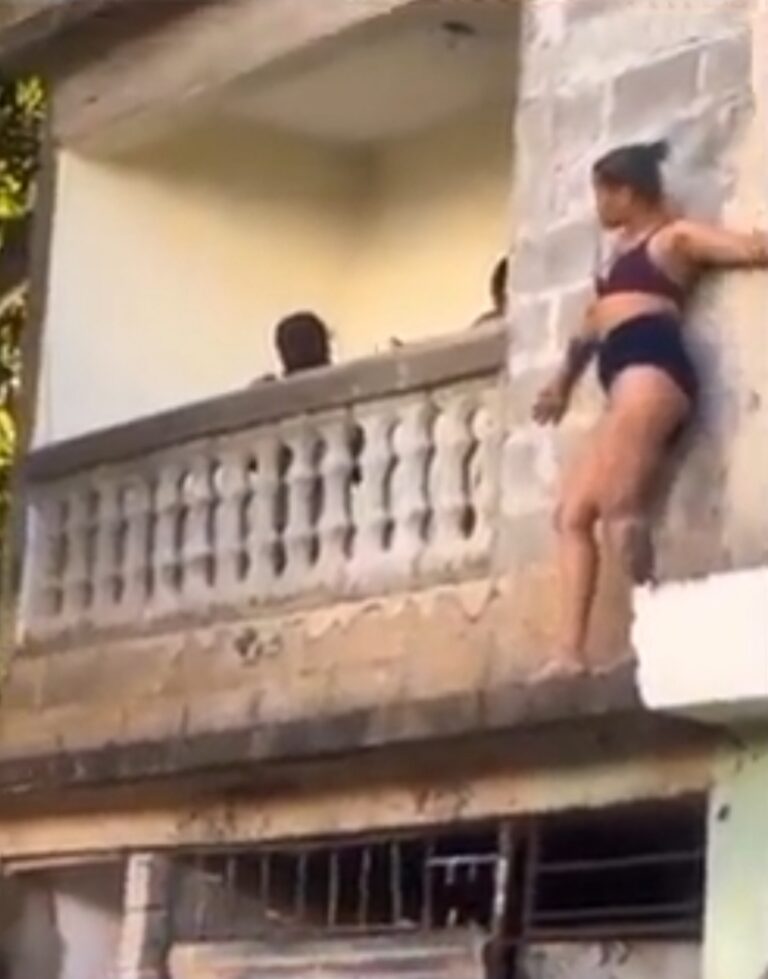 Scantily dressed side chick hides on balcony to avoid sugar daddy’s wife (Video)