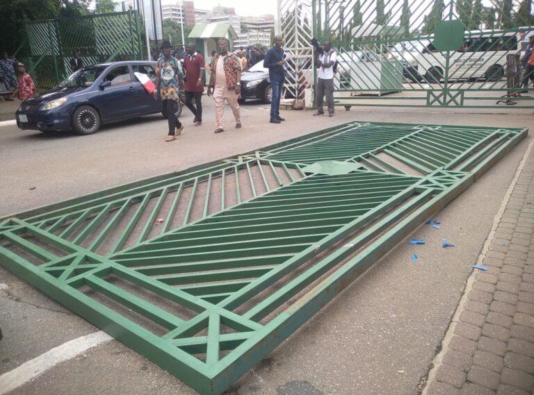 Protesters march to NASS complex, break down gate to gain entry