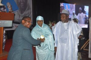 Hadizatu Uwani Mustapha receiving an award from the representative of the Chief Betty Akeredolu, wife of Ondo State Governor at a Neptune Prime event in March 2023 at Bauchi while Dr Hassan Gimba, publisher of Neptune Prime looked on with keen interest.